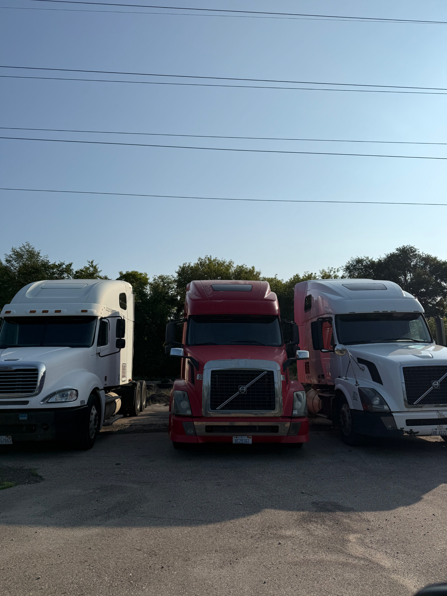 Freightliner and Volvo sleepers parked side by side